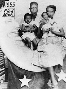 D O C T O R   R O S S' & family in Flint, MI, sitting on a moon-shaped prop in a Flint photographer's shop, 1955; source: 