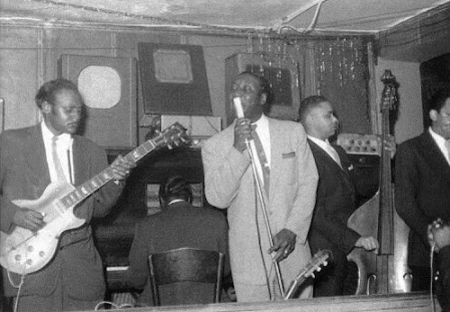 Muddy Waters Band at Sylvio's Lounge, Chicago, 1957; Pat Hare, g; Otis Spann, p; Muddy Waters, voc; not Big Crawford [died in March 1956!] Samuel 'Singin' Sam' Chatmon, b; unknown saxophonist; James Cotton, hca [only hands holding microphone visible]; source: https://de.pinterest.com/pin/440508407276721410/